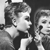Holly at 
 make-up mirror